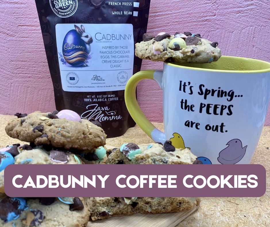A chewy Cadbunny Coffee Cookie with golden edges, topped with crushed Cadbury mini eggs and melty chocolate chips, resting on a pastel napkin with a glass of iced Cadbunny Coffee and a bag of coffee beans in the background.