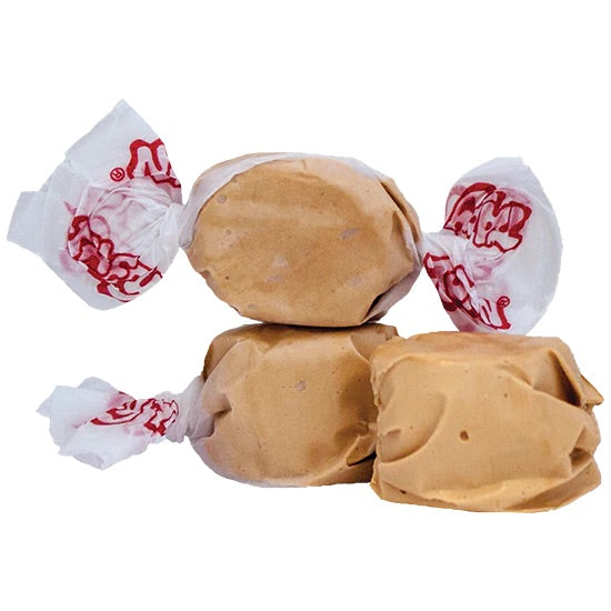 Three Maple Salt Water Taffy – Freeze-Dried Candy with Cozy, Caramelized Crunch pieces, wrapped in white wax paper with red writing, are stacked on a white background.
