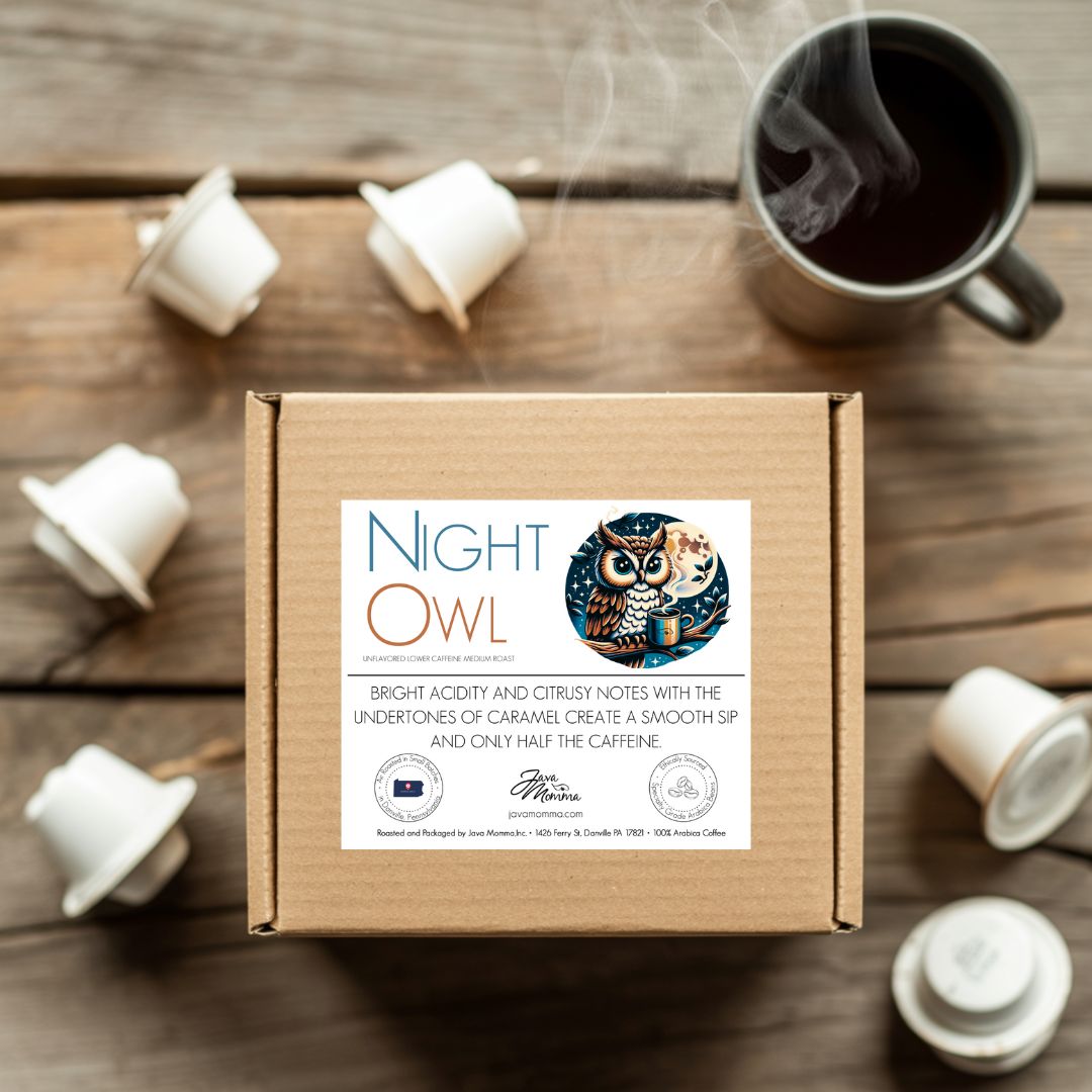 Box of Night Owl coffee with coffee cups and capsules on a wooden surface