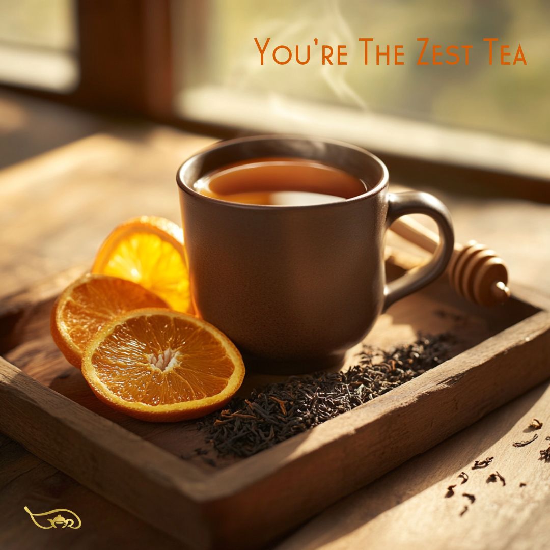 A sleek ceramic mug filled with rich amber-colored You're the Zest black tea, placed on a rustic wooden tray. Fresh orange slices, dried black tea leaves, and a honey dipper surround the cup, creating a warm and invigorating scene. Soft golden sunlight filters through a nearby window, enhancing the cozy yet refreshing citrus-inspired atmosphere.