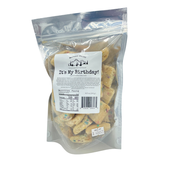 A clear, resealable bag of It’s My Birthday Biscotti Bites – Funfetti Meets Dunkable Bliss dog treats with a nutrition facts label and barcode on the front. Colorful-speckled biscuits make these perfect for birthday celebrations.