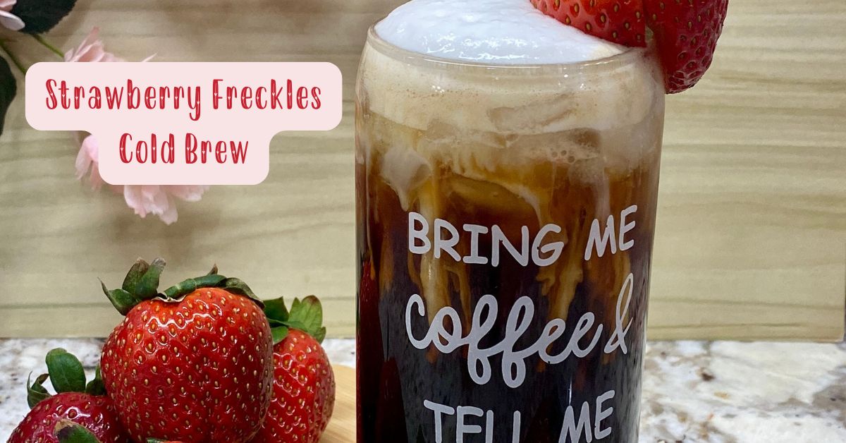 strawberry basil cold brew in tall glass, fresh strawberries to the side