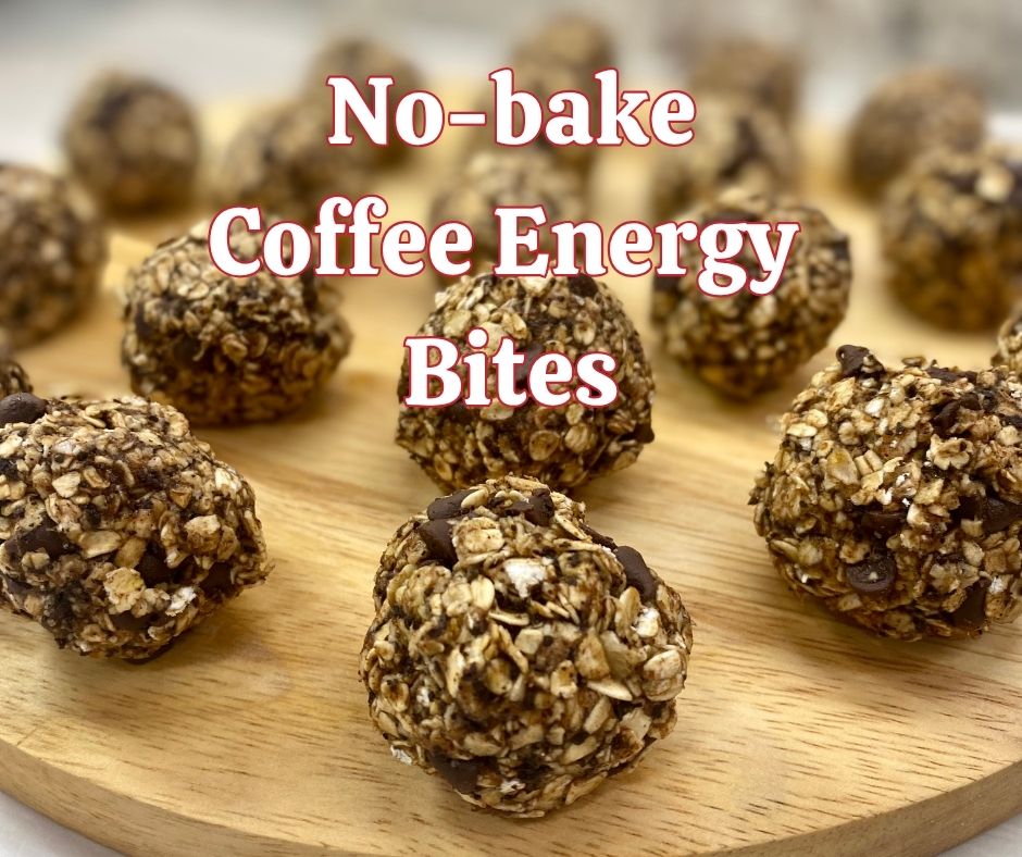 A close-up view of no-bake coffee energy bites arranged on a round wooden board. Each bite is packed with oats, chocolate chips, and visible coffee grounds. The text overlay reads “No-bake Coffee Energy Bites” in bold red and white lettering.