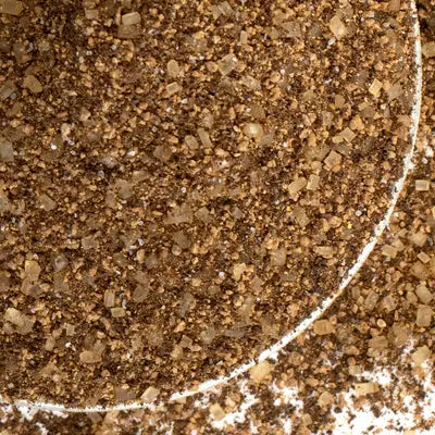 Close-up of caramel espresso seasoning with a circular white line.