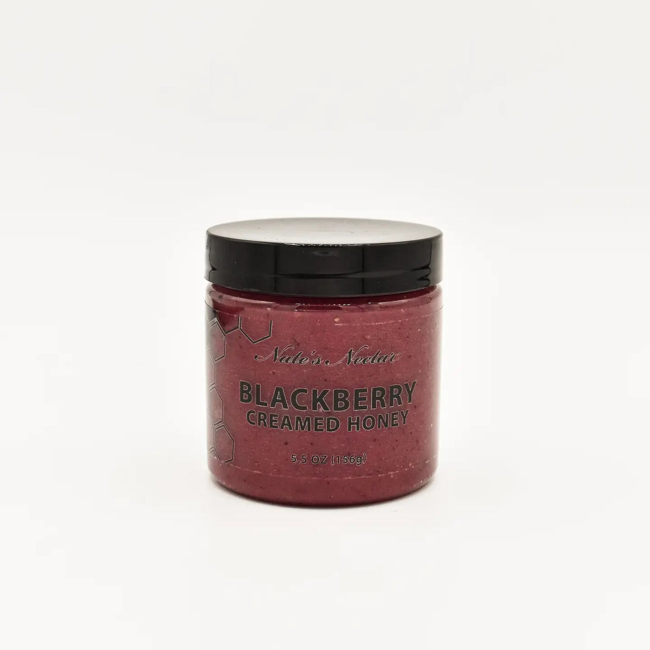 A jar of Nate’s Nectar Blackberry Creamed Honey – Berry Sweet & Spreadably Smooth with a black lid sits on a plain white background. The dark purple honey resembles blackberry jam. The jar contains 8.5 oz (255g) of raw honey.