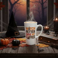 Thumbnail for The limited edition 17 oz Witch Better Have My Coffee Mug sits on a wooden table with pumpkins, autumn leaves, candles, a witch hat, and spider webs; a spooky forest is visible through the window.