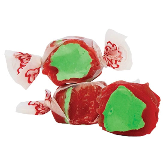 Three pieces of Candy Apple Salt Water Taffy, freeze-dried for a crunchy twist, feature a red outer layer with a green center—just like a classic candied apple. Ideal for fans of nostalgic flavors and unique sweet snacks.