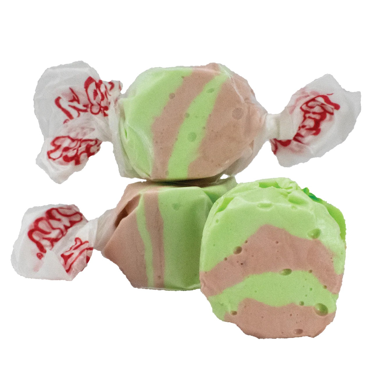 Three pieces of Dirty Soda Salt Water Taffy - Freeze-Dried Creamy Cola Candy with a Crunch, featuring green and brown stripes, two stacked and one in front, are isolated on a white background.