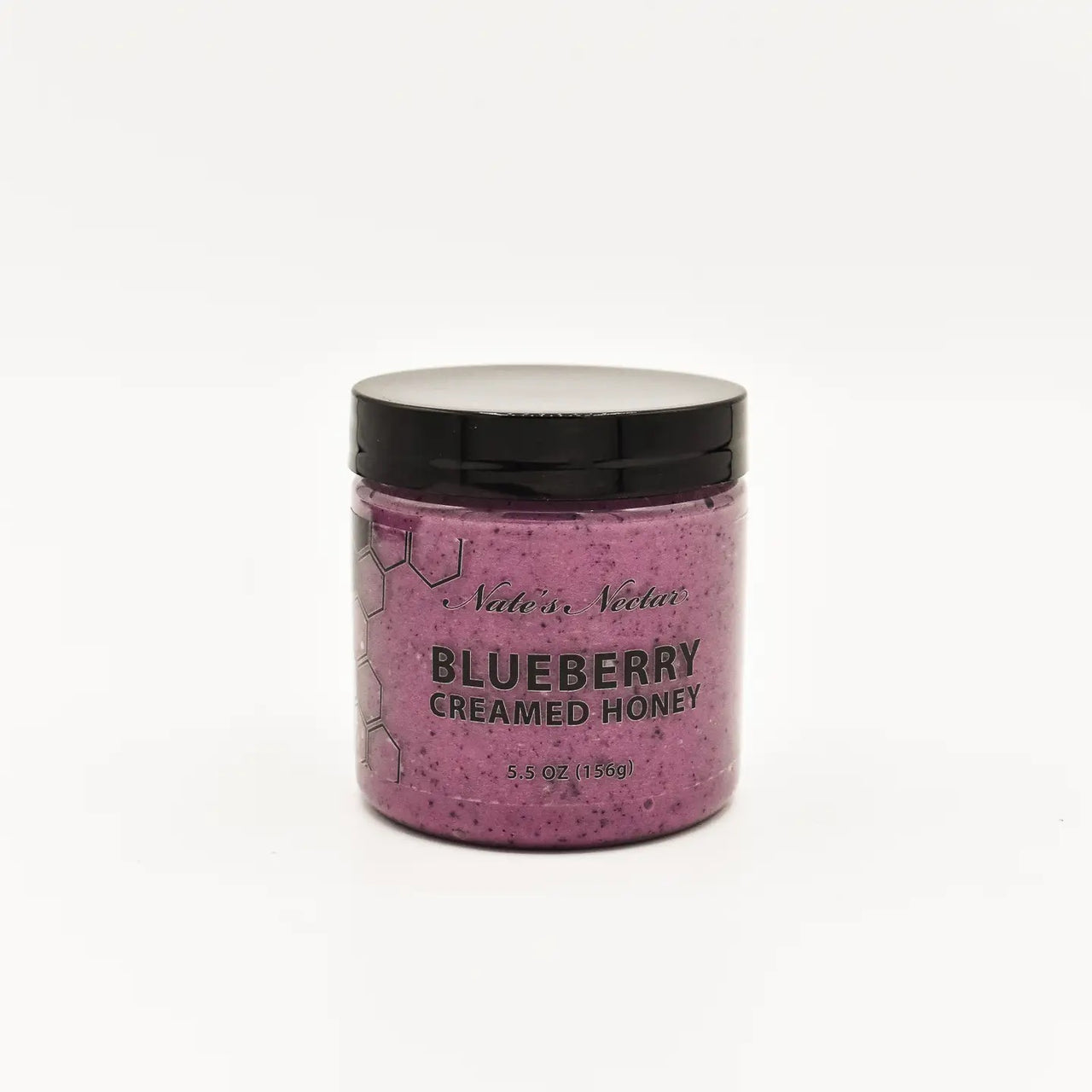 A jar of Nate’s Nectar Blueberry Creamed Honey 💙 with a black lid shows the purple, raw honey inside. The label reads BLUEBERRY CREAMED HONEY 5.5 OZ (156g). Set against a plain white background.