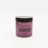 Thumbnail for A jar of Nate’s Nectar Blueberry Creamed Honey 💙 with a black lid shows the purple, raw honey inside. The label reads BLUEBERRY CREAMED HONEY 5.5 OZ (156g). Set against a plain white background.