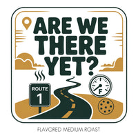 Thumbnail for Square label for ☕ Are We There Yet? – Chocolate & Irish Crème Flavored Coffee. Design includes road, Route 1 sign, fuel gauge, cookie, clouds, and a location pin. Bottom text: “Flavored Medium Roast with Silky Irish Crème.” Brown, black & white.