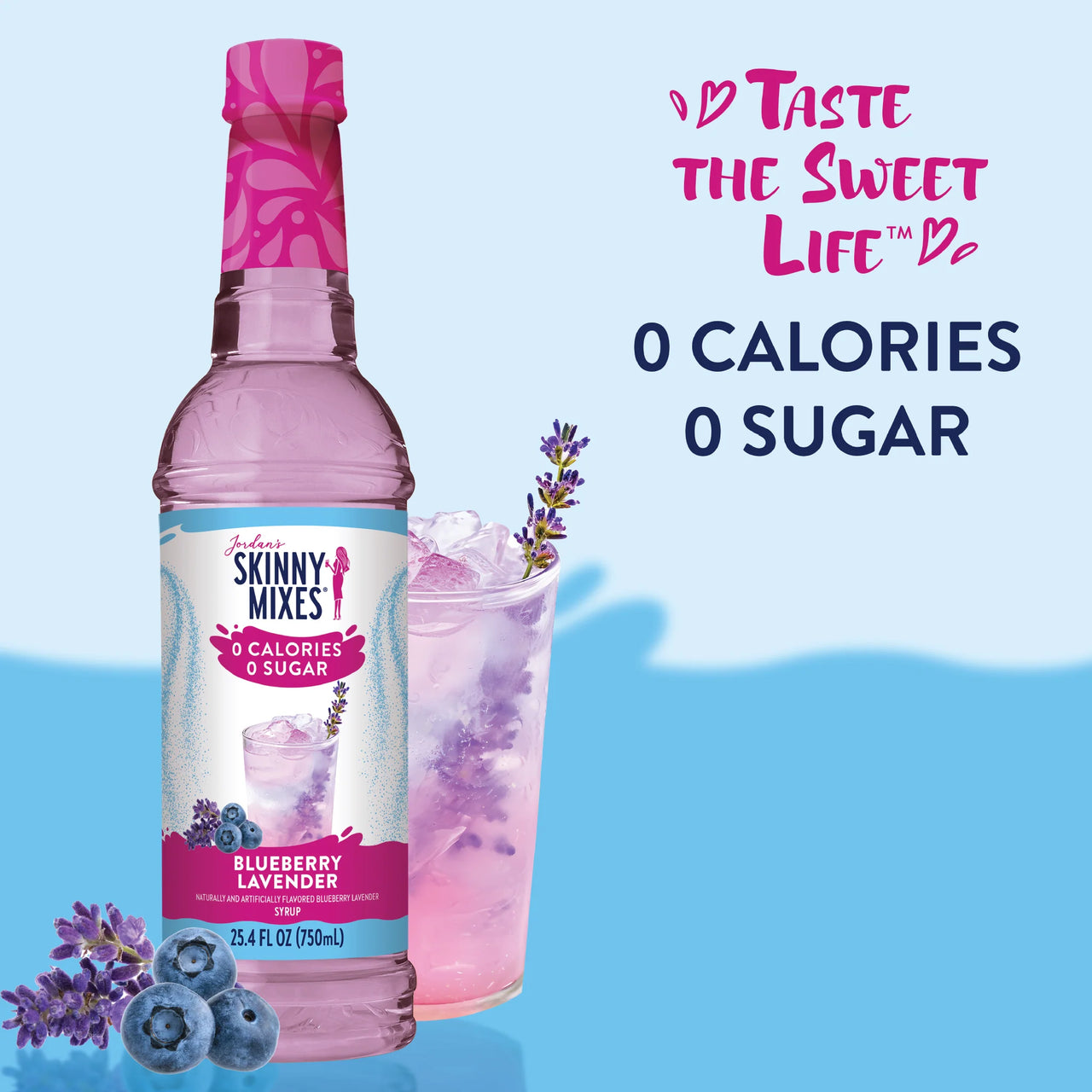 A bottle of Blueberry Lavender Skinny Syrup – Sweet. Soothing. Sophisticated. 💜🍇✨ sits beside a glass with a pink lavender drink, ice, blueberries, and a lavender sprig. Taste the Sweet Life: 0 Calories. 0 Sugar. Keto-friendly!.