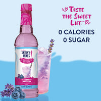Thumbnail for A bottle of Blueberry Lavender Skinny Syrup – Sweet. Soothing. Sophisticated. 💜🍇✨ sits beside a glass with a pink lavender drink, ice, blueberries, and a lavender sprig. Taste the Sweet Life: 0 Calories. 0 Sugar. Keto-friendly!.