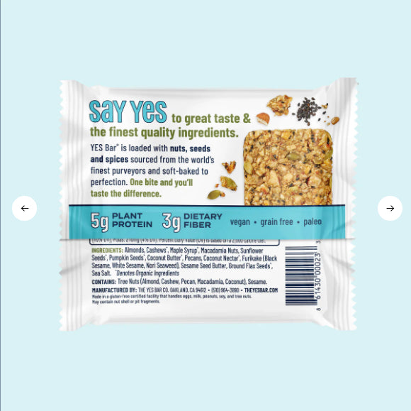 A packaged Black Sesame Sea Salt YES Bar®—Sweet, Savory, and Totally Addictive—against a light blue background. The gluten-free bar is vegan, paleo, and grain-free with plant protein, fiber, nuts, seeds, and spices.