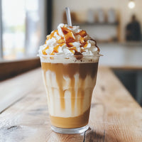 Thumbnail for A plastic cup holds a sugar-free caramel macchiato made with Caramel Macchiato Skinny Syrup – Barista Bliss in a Bottle ☕🍮✨, topped with whipped cream and caramel drizzle, resting on a wooden table in a softly lit café.