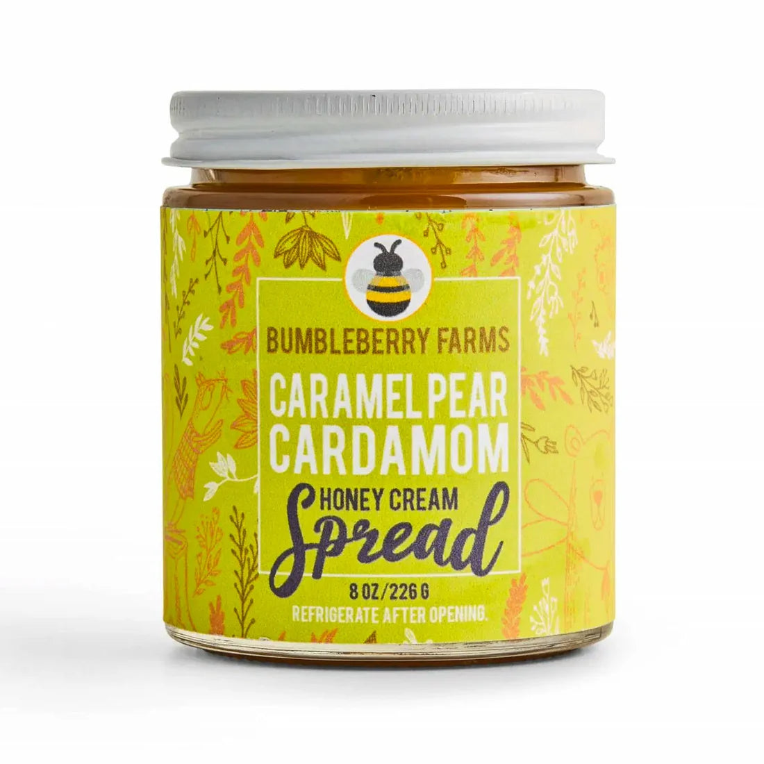 A jar of Bumbleberry Farms Caramel Pear Cardamom Honey Cream Spread on a white background. The jar has a white lid and a yellow label with illustrations of a bee and botanical patterns.
