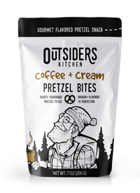 Thumbnail for A white bag labeled Coffee + Cream Pretzel Bites – Sweet, Salty, and Seriously Addictive ☕✨, shows a bearded person with a hat and mug in a forest. Enjoy small batch snacks with rich coffee flavor. Net weight: 7 oz (200 g).