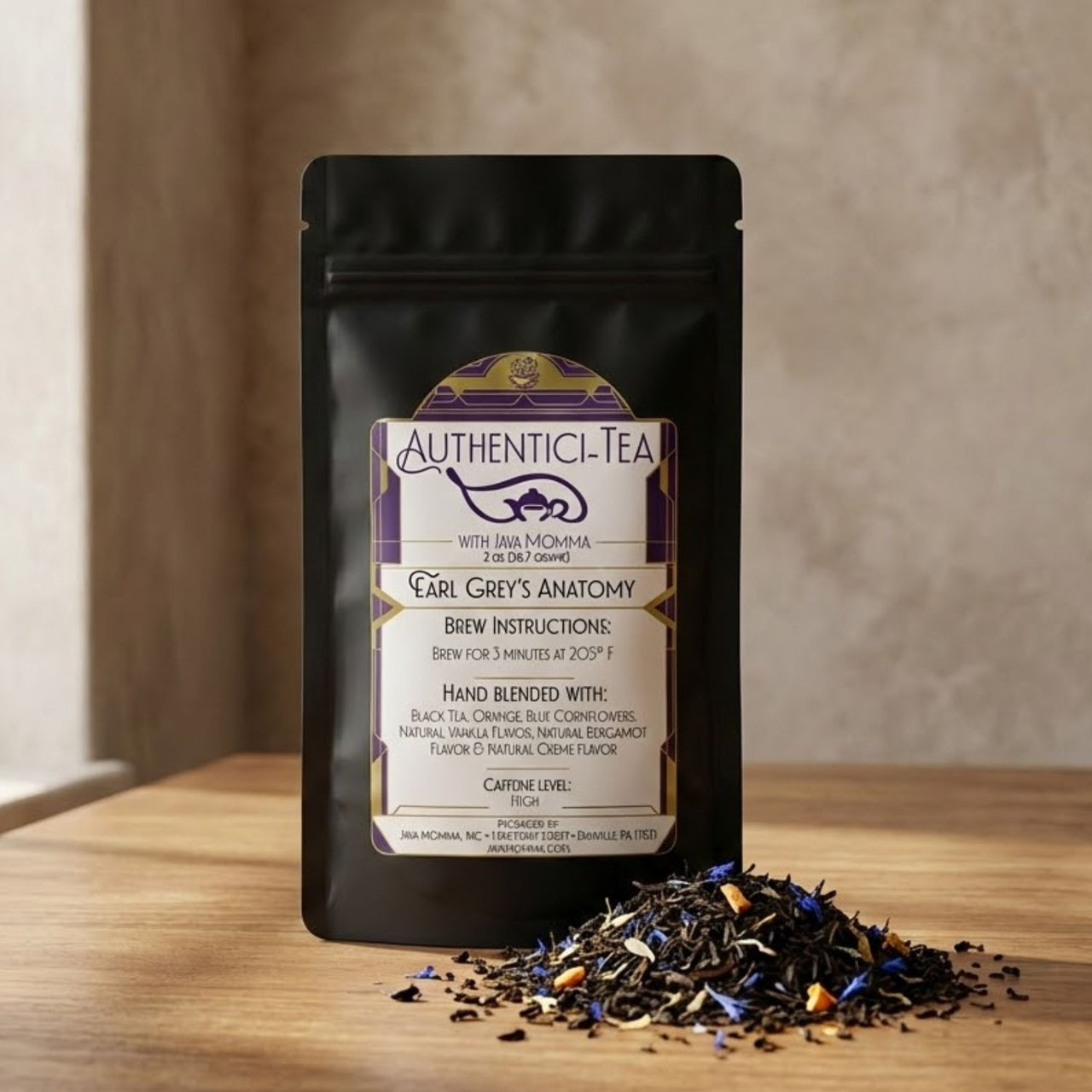 Authentici-Tea Earl Grey’s Anatomy loose leaf tea pouch with pile of black tea, bergamot pieces, and cornflower petals on wooden table.