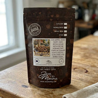 Thumbnail for Java Momma Forest Berry Pie 
coffee package on a wooden surface with a blurred background