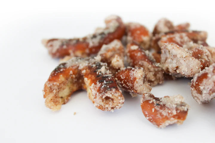Close-up of Sugar + Spice Pretzel Bites – Sweet, Salty, and Straight-Up Craveable 🍬🔥, broken into chunks and dusted with white sugar and cinnamon. Made in small batches for the perfect sweet and salty treat on a white background.