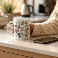 Thumbnail for Regency drama tea mug featuring floral design with the text 'I am the Tea you are Having' on a kitchen counter.