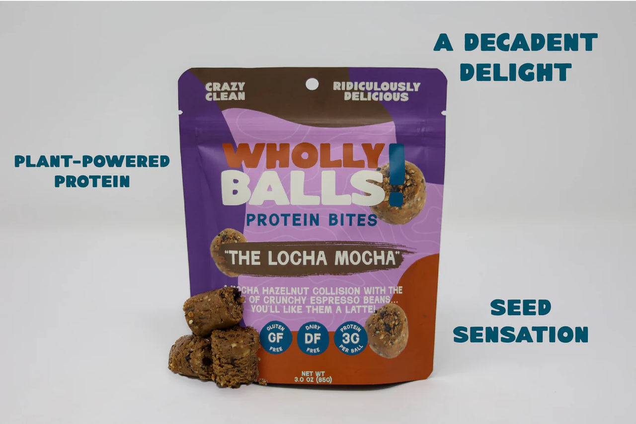 A vibrant bag of The Loca Mocha – Mocha Hazelnut Espresso Wholly Balls | Plant-Based Protein Snack stands upright, surrounded by coffee protein bites. Bold text highlights “A Decadent Delight,” “Plant-Powered Protein,” and “Seed Sensation.”.