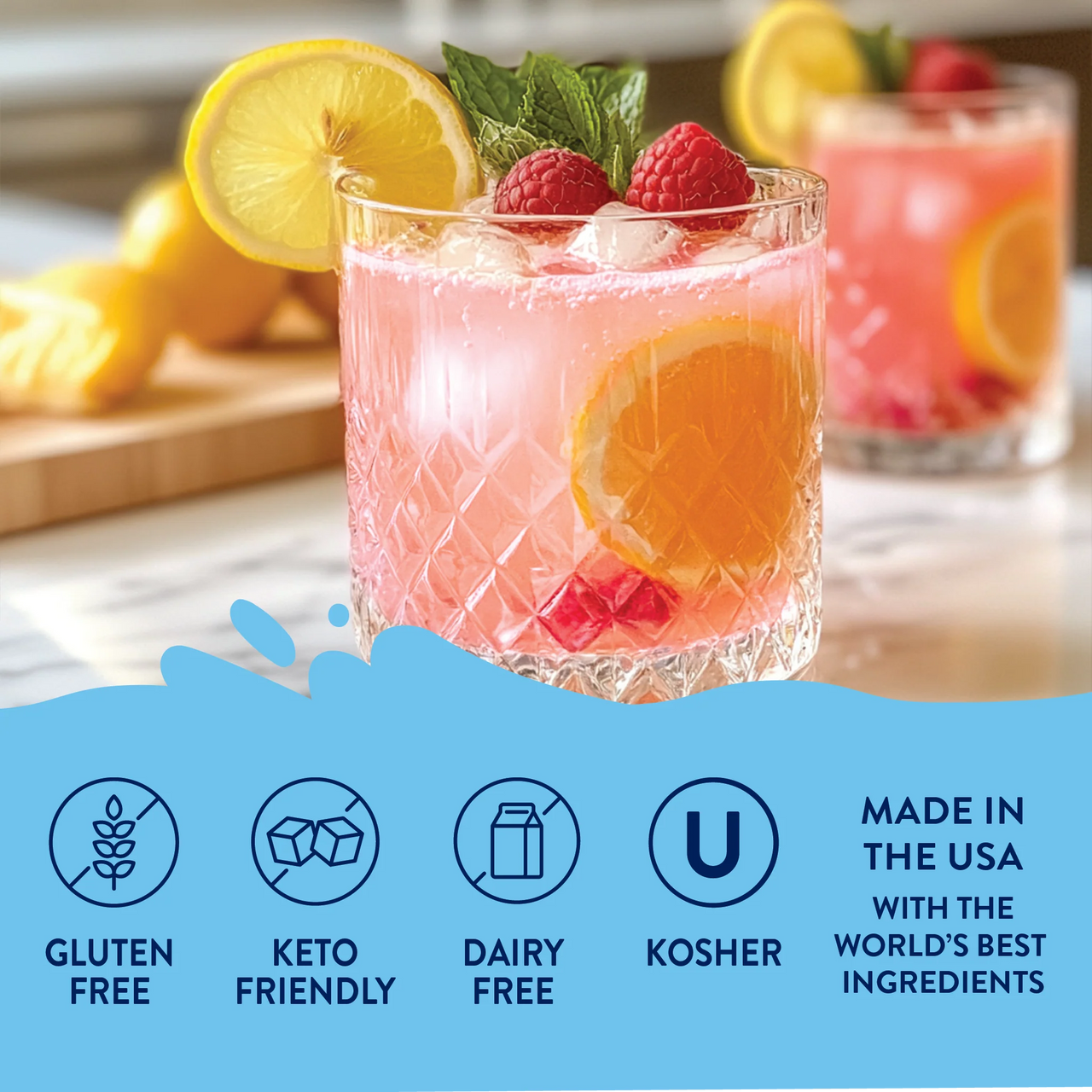 A glass of pink lemonade with lemon slices, raspberries, and mint sits on a table, made with Meyer Lemon Raspberry Skinny Syrup – Sweet Meets Zesty in Every Sip 🍋💗✨. Gluten free, keto friendly, dairy free, kosher. Made in the USA with premium ingredients.