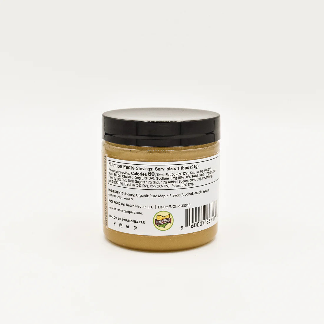 A small jar with a black lid, shown from the back, displays nutrition facts and ingredients for Nate’s Nectar Maple 🍁 Creamed Honey – Cozy, Sweet & Spreadably Smooth. A barcode appears at the bottom.