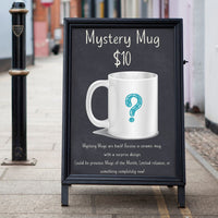 Thumbnail for A sidewalk chalkboard advertises the $10 Mystery Mug—a ceramic white mug with a blue question mark. Each mug is a surprise, featuring limited-edition designs, past favorites, or new styles.
