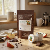 Thumbnail for Nicaragua Diamante Coffee package with coffee beans, apples, and a coffee pod on a wooden surface.