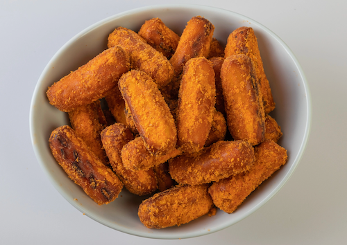A white bowl filled with golden-brown OMG Pretzels - Buffalo Sourdough Pretzel Nuggets sits against a plain light background—an ideal snack for those craving crispy, flavorful pretzel bites.
