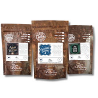 Thumbnail for The Momma’s Picks Monthly Coffee Box features three exclusive flavored blends—Amas Veritas, Enchanted Evening, and No Good Deed—in brown bags with white labels. Crafted by Java Momma, they’re perfect for a cozy candlelit coffee night.