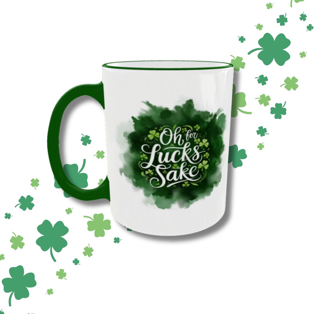 A festive St. Patrick’s Day mug with a white base, green handle, and green rim features the playful phrase "Oh, For Luck’s Sake" in stylish white lettering against a watercolor shamrock background. Surrounding the mug are scattered green shamrocks, adding to the lucky Irish theme. Perfect for celebrating St. Paddy’s Day with a fun and lucky sip! 