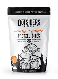 Thumbnail for A white 7 oz (200 g) bag of Orange + Ginger Pretzel Bites – Zesty, Creamy, and Boldly Delicious 🍊🔥 features sourdough bites and an illustrated bearded man in glasses and a winter hat among trees and a pretzel.
