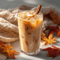 Thumbnail for A Pumpkin Spice Latte Packet 🎃 sits on the table amid knit fabric and autumn leaves in warm sunlight—the perfect cozy fall coffee moment with every sip.
