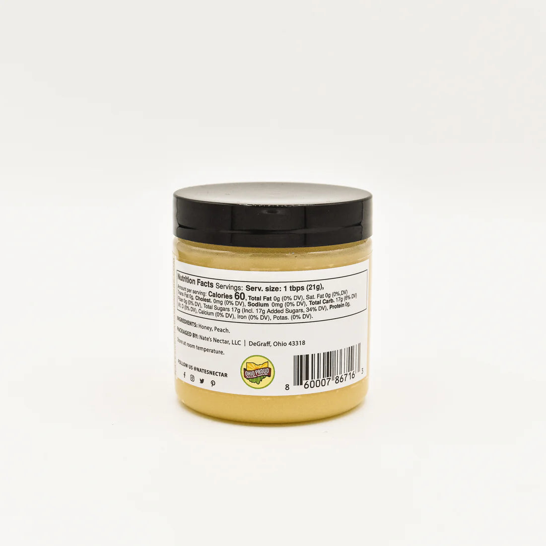 A small jar of Nate’s Nectar Peach 🍑 Creamed Honey – Juicy, Sweet & Perfectly Spreadable with a black lid displays its back label, showing nutrition facts, ingredients, and a barcode against a plain white background.