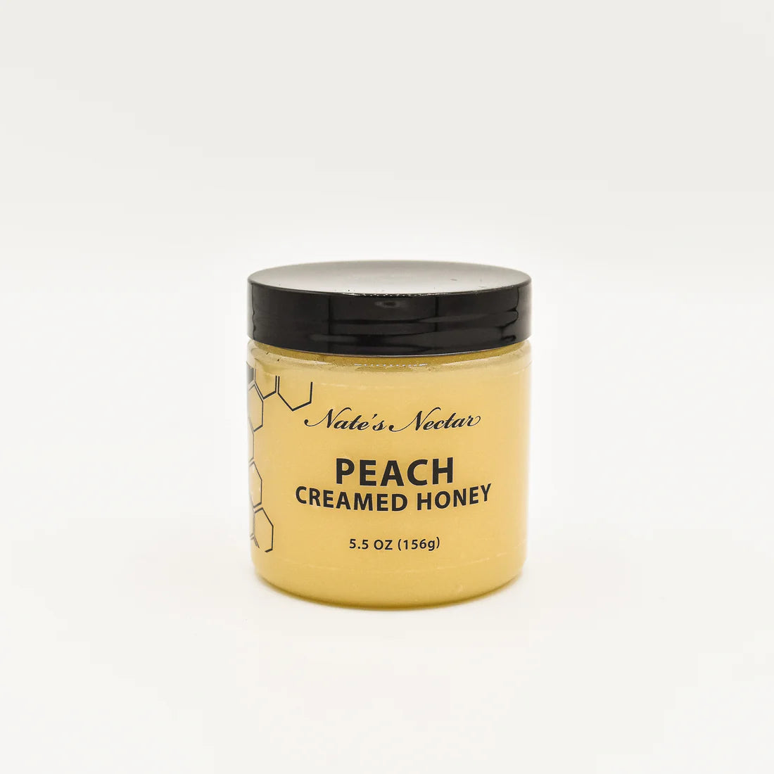 A 5.5 oz jar of Nate’s Nectar Peach 🍑 Creamed Honey – Juicy, Sweet & Perfectly Spreadable; comes with a black lid and features black text with a honeycomb design on a plain white label.