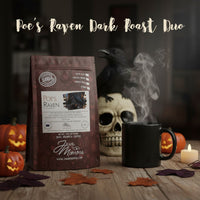 Thumbnail for A coffee bag labeled Poe’s Raven Dark Roast sits by a steaming mug, skull with a gothic raven figurine, autumn leaves, candle, and black mug. Above: Poe’s Raven Dark Roast Duo – Limited Edition Coffee + Raven Figurine.