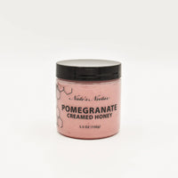 Thumbnail for A 5.5 oz (156g) jar of Nate’s Nectar Pomegranate Creamed Honey – Bold, Sweet & Irresistibly Smooth features a black lid, pink creamed honey, and a simple hexagon-designed label, shown against a plain white background.