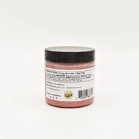 Thumbnail for A jar with a black lid containing pink Nate’s Nectar Raspberry Creamed Honey is shown from the back. The label features nutrition facts, ingredients, a barcode, and logo, but text is too small to read. Background is plain white.