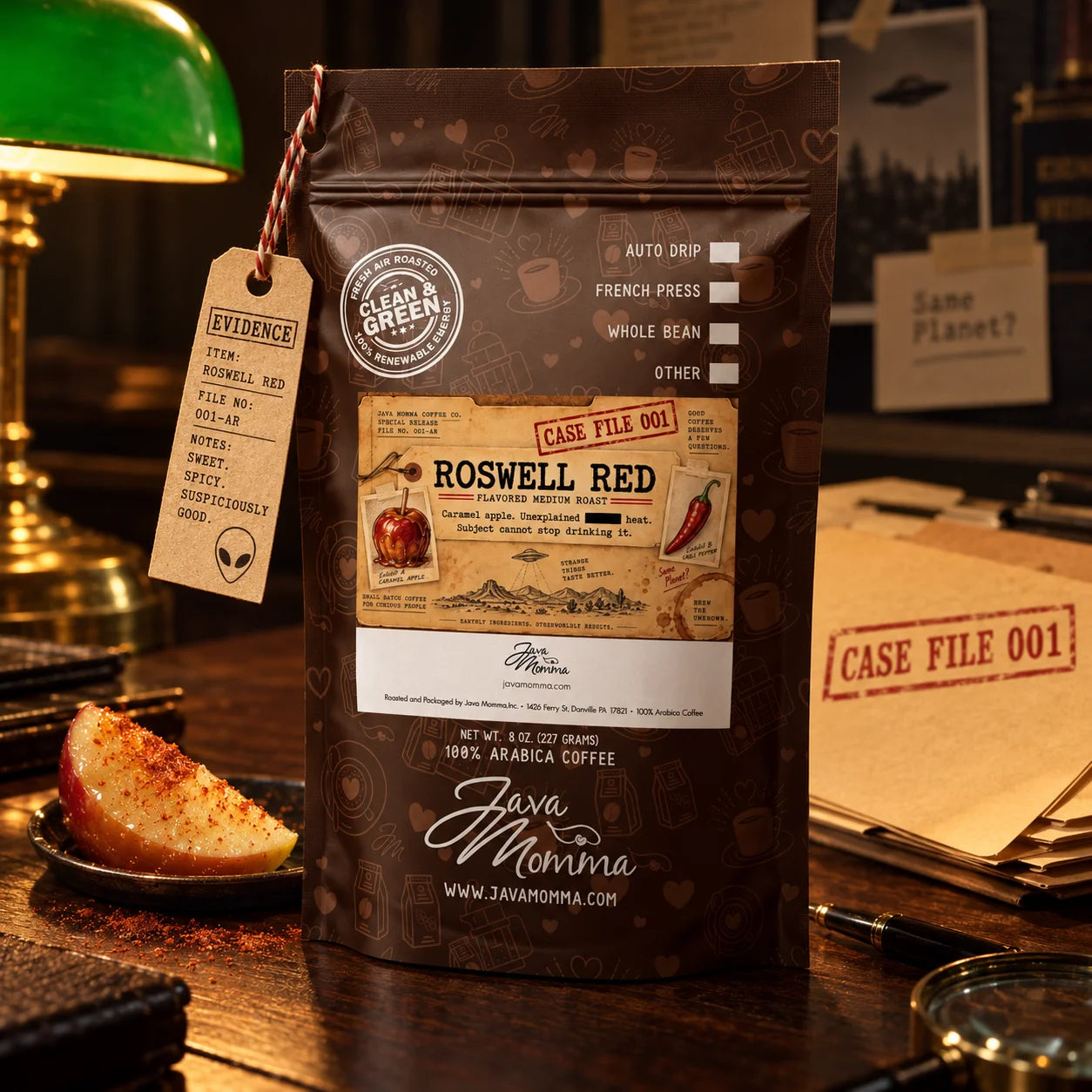 Roswell Red Coffee | Momma's Picks pack featuring caramel apple and cayenne heat on a detective-themed desk.
