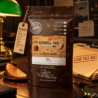 Thumbnail for Roswell Red Coffee | Momma's Picks pack featuring caramel apple and cayenne heat on a detective-themed desk.