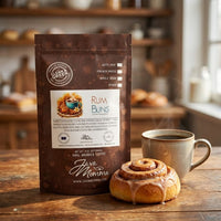 Thumbnail for Java Momma coffee package with a cinnamon roll and steaming cup of coffee on a wooden table.
