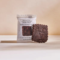 Thumbnail for A packaged Double Chocolate Shortbread Cookie 🍫 – Rich, Buttery & Single-Serve Decadence stands upright, with an unwrapped handcrafted double chocolate shortbread leaning against it on a neutral background.