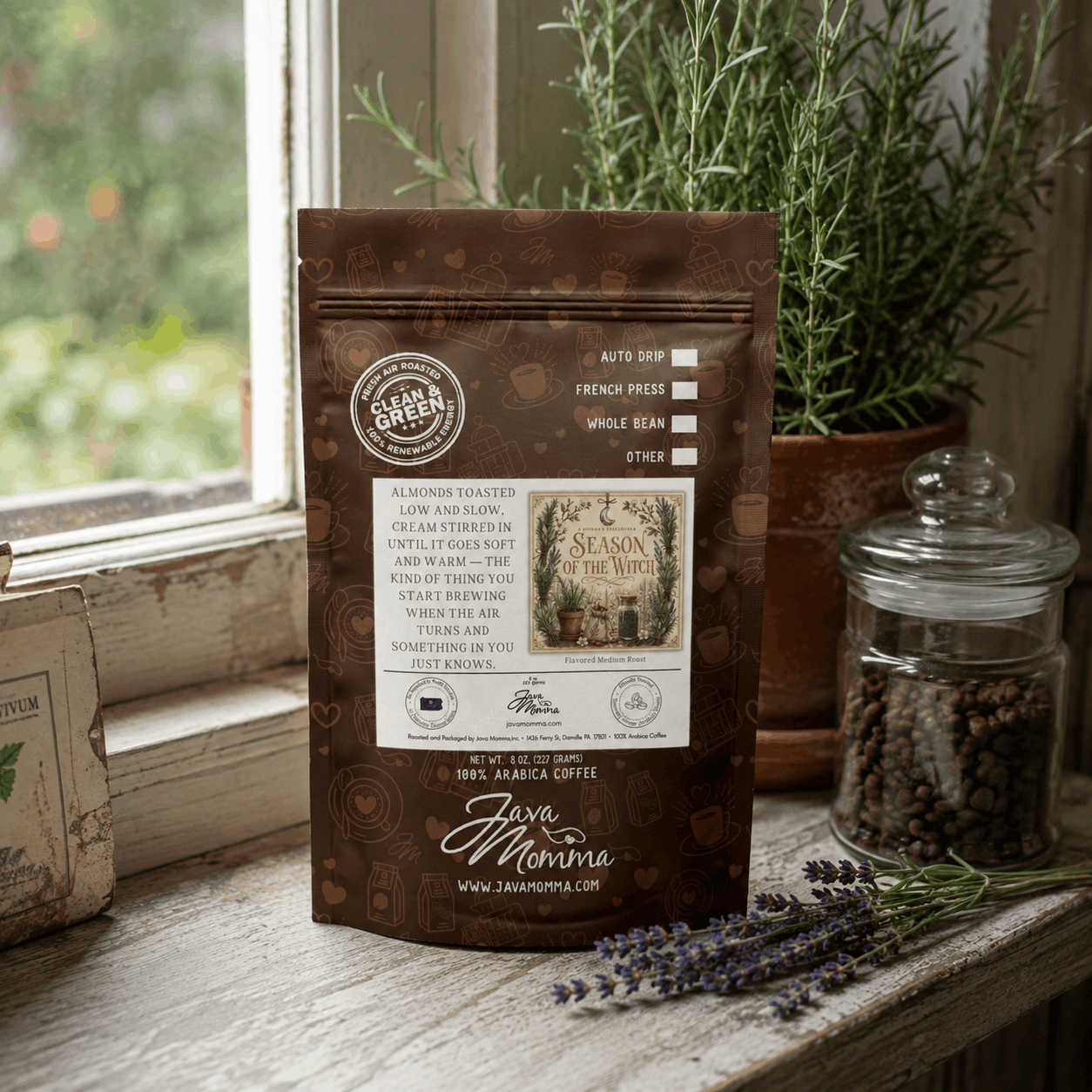 Packet of Season of the Witch Flavored Coffee displayed in a cozy kitchen with herbs and coffee beans.