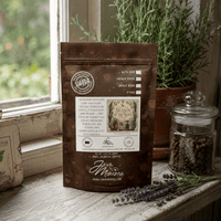Thumbnail for Packet of Season of the Witch Flavored Coffee displayed in a cozy kitchen with herbs and coffee beans.