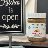 Thumbnail for A jar of Shortbread Cookie 🫓 with Monk Fruit Nut Butter – Buttery, Sweet & Sugar-Free Bliss, featuring cookie images and a white lid, sits by a chalkboard sign that reads “Kitchen is open.” It highlights its sugar-free, monk fruit nut butter recipe.