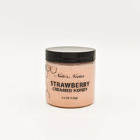 Thumbnail for A jar of Nate’s Nectar Strawberry Creamed Honey 🍓 with a black lid and clear container showing pink honey, labeled in black text, is set against a plain white background.