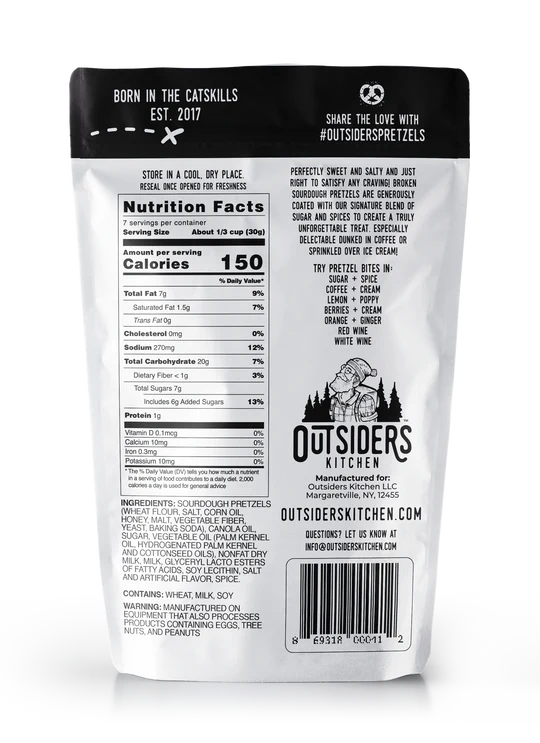 Back of a bag of Sugar + Spice Pretzel Bites – Sweet, Salty, and Straight-Up Craveable 🍬🔥 shows nutrition facts, brand story, social info, and barcode. The white pack with black text and mountain logo spotlights these sourdough pretzel snacks.