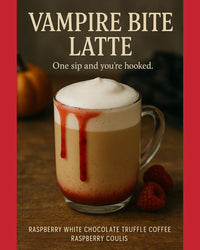 Thumbnail for A glass mug of latte with foamy top and raspberry coulis resembling vampire bite marks drips down the side. Fresh raspberries and a pumpkin are nearby. Try our White Chocolate Raspberry Flavored Coffee—a wickedly delicious treat!.